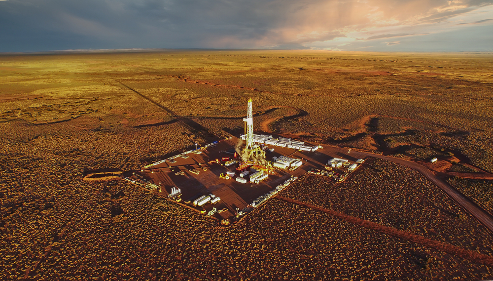 Aerial photo of hydraulic fracturing equipment at sunset, fracking.
