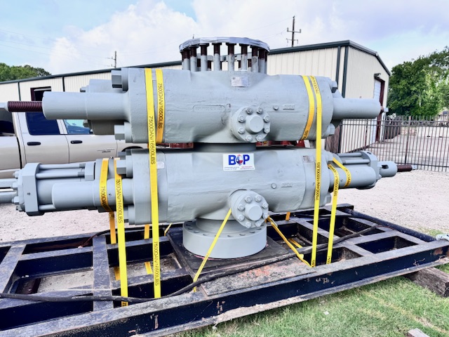 Surface blowout preventer (BOP) stack secured on a transport skid, showing hydraulic rams and well control components
