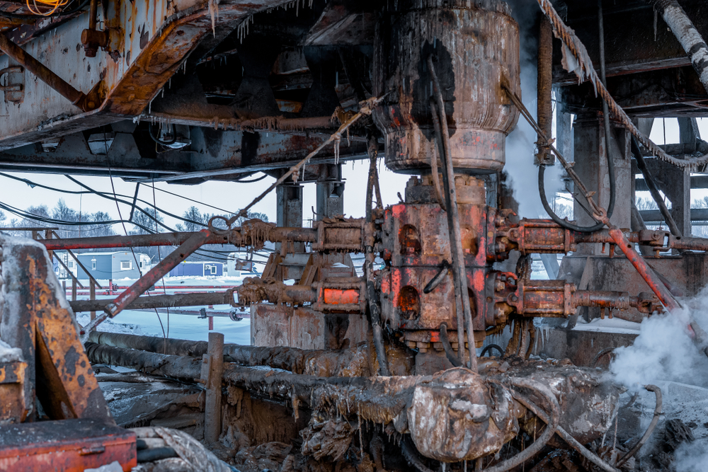 Drilling rig crew preparing to install a blowout preventer during well operations.