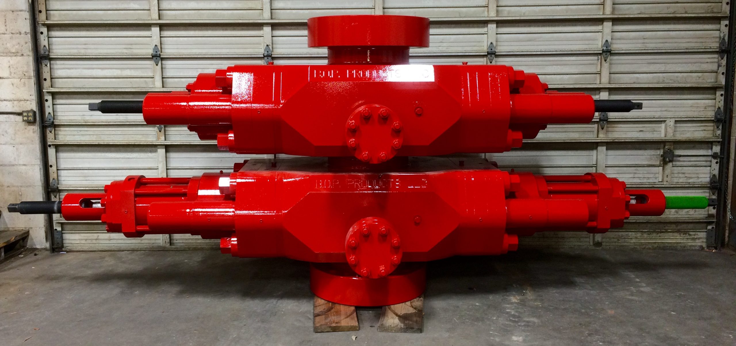 Two double ram blowout preventers positioned in a workshop, illustrating pressure-control equipment used for well control and drilling safety.