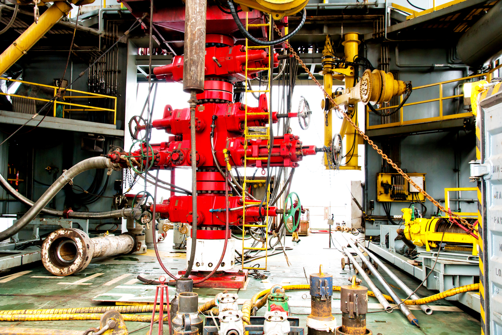 BlowoutPreventerValvebopIsALargeValveAtThe Blowout preventer (BOP) installed on an oil and gas wellhead, highlighting equipment subject to routine inspection and maintenance.