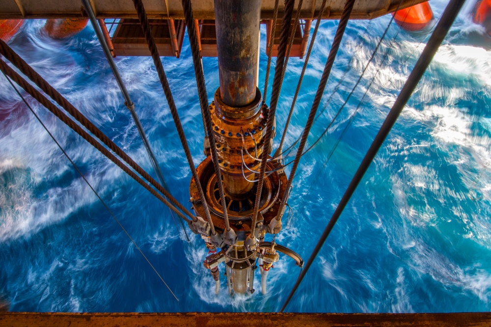 Subsea blowout preventer array being lowered into the sea for offshore drilling